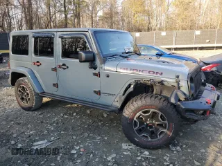 2015 Jeep Wrangler Unlimited Rubicon Hard Rock with VIN 1C4HJWFGXFL671660, listed as a Copart auction lot 82329074 with 214,579 mi miles and Salvage title. Bid and sale history available at DreamBid. Image 4.