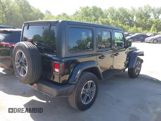 2023 Jeep Wrangler Sahara with VIN 1C4HJXEN5PW702268, listed as a IAAI auction lot 42288704 with 57,240 mi miles and . Bid and sale history available at DreamBid. Image 4.