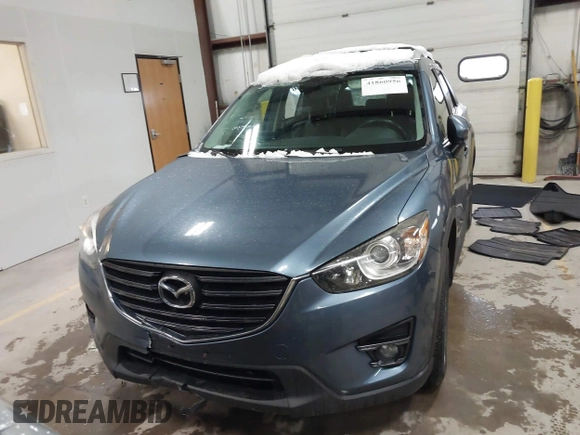 2016 Mazda CX-5 Grand Touring z VIN JM3KE4DY9G0714468, wystawiony jako IAAI lot #41860956 z przebiegiem 114 481 mil mil oraz . Historia ofert i sprzedaży dostępna na DreamBid. Obrazek 12.