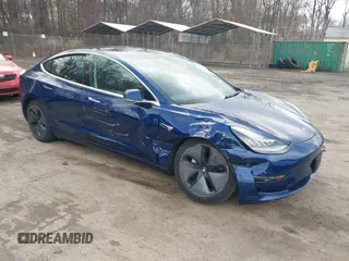 2019 Tesla Model 3 Mid Range with VIN 5YJ3E1EA5KF299589, listed as a IAAI auction lot 41709733 with 50,256 mi miles and . Bid and sale history available at DreamBid. Image 1.