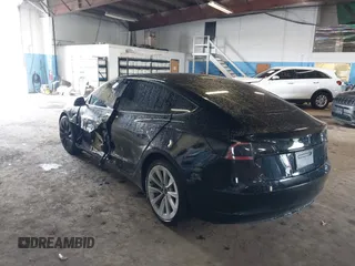 2023 Tesla Model 3 with VIN 5YJ3E1EA5PF396413, listed as a IAAI auction lot 42188639 with 57,717 mi miles and . Bid and sale history available at DreamBid. Image 3.