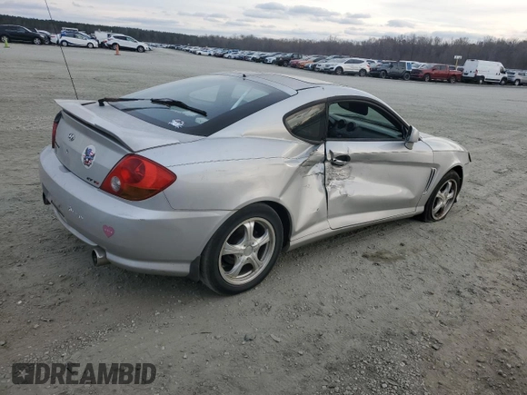2003 Hyundai Tiburon GT z VIN KMHHN65F63U064962, wystawiony jako Copart lot #44804045 z przebiegiem 186 171 mil mil oraz Szkoda całkowita • Salvage title. Historia ofert i sprzedaży dostępna na DreamBid. Obrazek 3.