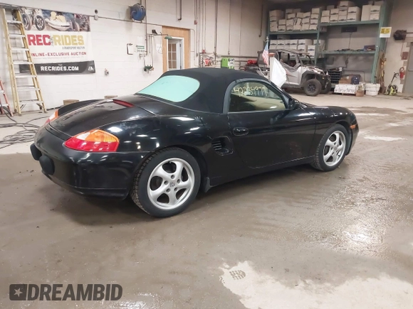 1999 Porsche Boxster z VIN WP0CA2984XU622814, wystawiony jako IAAI lot #42234977 z przebiegiem 52 404 mil mil oraz . Historia ofert i sprzedaży dostępna na DreamBid. Obrazek 4.