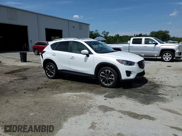 2016 Mazda CX-5 Grand Touring z VIN JM3KE2DYXG0731462, wystawiony jako Copart lot #58220465 z przebiegiem 130 033 mil mil oraz Szkoda całkowita • Salvage title. Historia ofert i sprzedaży dostępna na DreamBid. Obrazek 14.