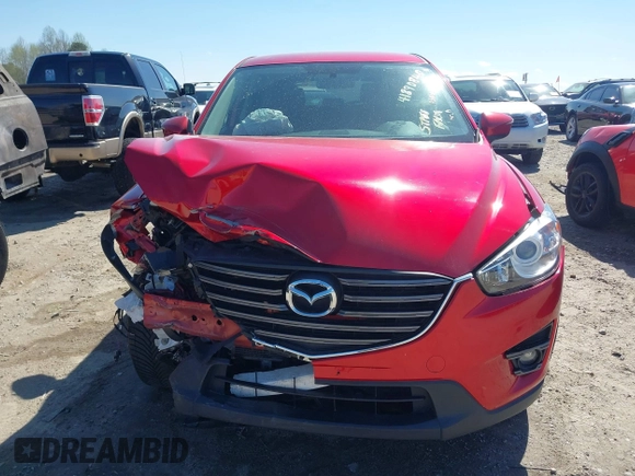 2016 Mazda CX-5 Touring with VIN JM3KE4CY0G0890309, listed as a IAAI auction lot 41890840 with 89,023 mi miles and . Bid and sale history available at carsss.com. Image 12.