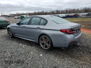 2023 BMW 5 Series M550i xDrive with VIN WBA13BK06PCN02733, listed as a Copart auction lot 48767235 with 27,725 mi miles and Salvage title. Bid and sale history available at DreamBid. Image 2.
