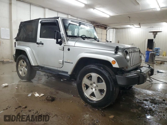 2009 Jeep Wrangler Sahara z VIN 1J4FA54189L789642, wystawiony jako Copart lot #89078145 z przebiegiem 128 902 mil mil oraz Szkoda całkowita • Salvage title. Historia ofert i sprzedaży dostępna na DreamBid. Obrazek 4.