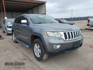 2013 Jeep Grand Cherokee Laredo with VIN 1C4RJEAG2DC571569, listed as a IAAI auction lot 41100518 with 98,265 mi miles. Bid and sale history available at carsss.com. Image 1.