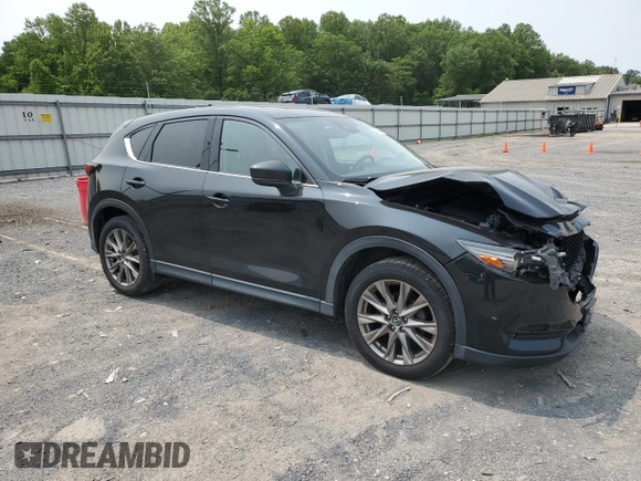2019 Mazda CX-5 Grand Touring with VIN JM3KFBDM2K0569829, listed as a Copart auction lot 59060965 with 99,359 mi miles and Salvage title. Bid and sale history available at DreamBid. Image 4.