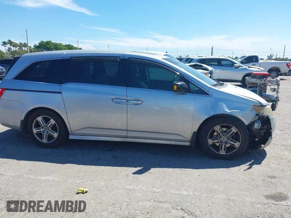 2012 Honda Odyssey Touring with VIN 5FNRL5H90CB099519, listed as a IAAI auction lot 41854550 with 185,110 mi miles. Bid and sale history available at carsss.com. Image 14.