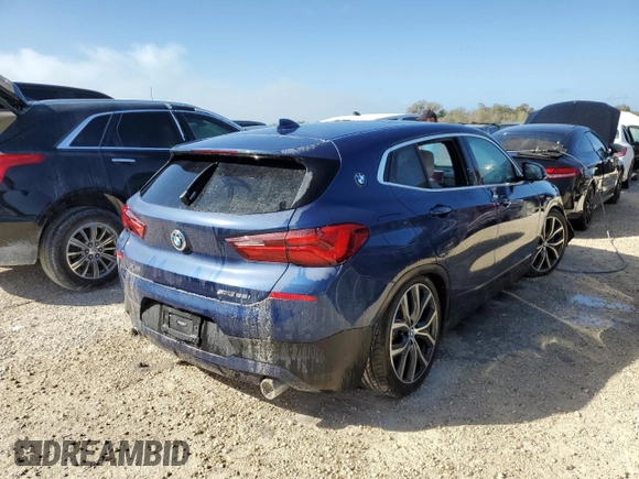 2021 BMW X2 sDrive28i with VIN WBXYH9C02M5S54591, listed as a Copart auction lot 77223834 with 0 mi miles and Salvage Title. Bid and sale history available at carsss.com. Image 3.