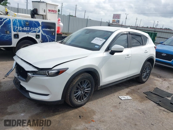 2020 Mazda CX-5 Touring z VIN JM3KFBCM2L0786784, wystawiony jako IAAI lot #42127457 z przebiegiem 62 665 mil mil oraz . Historia ofert i sprzedaży dostępna na DreamBid. Obrazek 2.