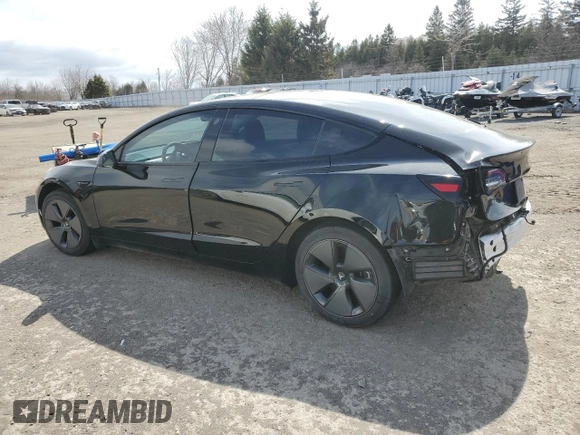 2021 Tesla Model 3 Standard Range Plus with VIN 5YJ3E1EA7MF053663, listed as a Copart auction lot 51982265 with 90,529 mi miles and Salvage Title. Bid and sale history available at DreamBid. Image 2.