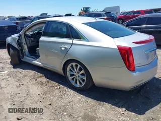 2014 Cadillac XTS Luxury z VIN 2G61M5S31E9199170, wystawiony jako IAAI lot #42150000 z przebiegiem 135 414 mil mil oraz . Historia ofert i sprzedaży dostępna na DreamBid. Obrazek 3.
