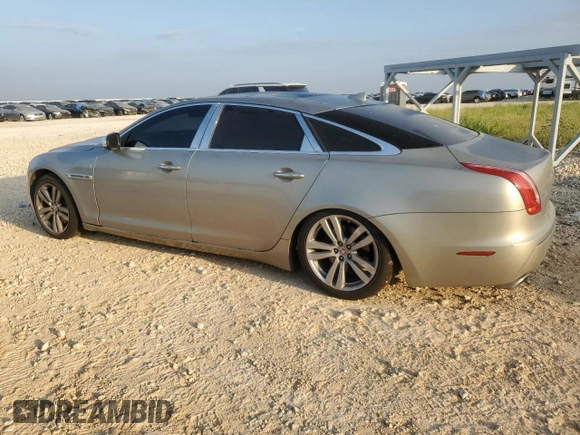 2014 Jaguar XJ Portfolio with VIN SAJWJ2GD7E8V61558, listed as a Copart auction lot 66850034 with 130,984 mi miles and Salvage title. Bid and sale history available at DreamBid. Image 2.