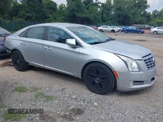 2014 Cadillac XTS Luxury z VIN 2G61N5S38E9270619, wystawiony jako IAAI lot #40140617 z przebiegiem 117 286 mil mil oraz . Historia ofert i sprzedaży dostępna na DreamBid. Obrazek 1.