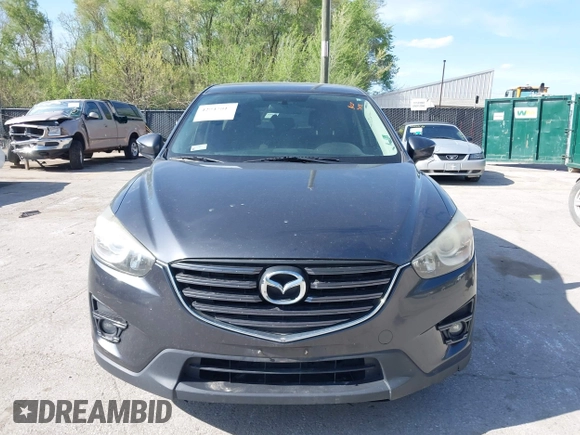 2016 Mazda CX-5 Touring z VIN JM3KE2CY4G0708972, wystawiony jako IAAI lot #42043013 z przebiegiem 157 573 mil mil oraz . Historia ofert i sprzedaży dostępna na DreamBid. Obrazek 6.