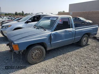 1988 Toyota Pickup z VIN JT4RN50RXJ0362147, wystawiony jako Copart lot #59809015 z przebiegiem 419 106 mil mil oraz Czysty tytuł • Clean title. Historia ofert i sprzedaży dostępna na DreamBid. Obrazek 1.