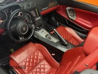 2013 Lamborghini Gallardo z VIN ZHWGU6BZ7DLA12511, wystawiony jako Copart lot #85780924 z przebiegiem 35 386 mil mil oraz Szkody całkowita. Historia ofert i sprzedaży dostępna na DreamBid. Obrazek 7.