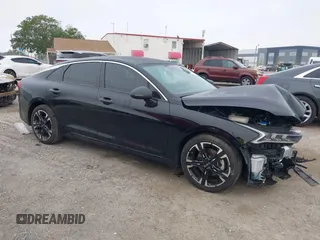 2023 Kia K5 GT-Line z VIN 5XXG64J25PG200210, wystawiony jako IAAI lot #41912838 z przebiegiem 21 483 mil mil oraz . Historia ofert i sprzedaży dostępna na DreamBid. Obrazek 1.