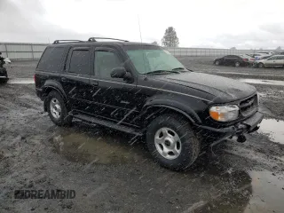 2000 Ford Explorer Limited with VIN 1FMDU75EXYZA76329, listed as a Copart auction lot 80952474 with 90,637 mi miles and Salvage title. Bid and sale history available at DreamBid. Image 4.