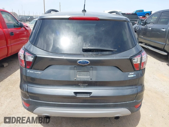 2018 Ford Escape SE z VIN 1FMCU9G98JUC13620, wystawiony jako IAAI lot #42011272 z przebiegiem 71 677 mil mil oraz . Historia ofert i sprzedaży dostępna na DreamBid. Obrazek 16.