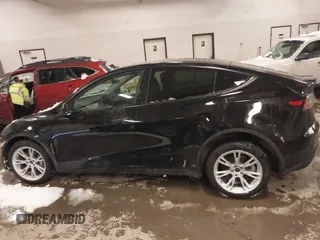 2024 Tesla Model Y Long Range with VIN 7SAYGDEEXRF085795, listed as a IAAI auction lot 41609867 with 57,049 mi miles. Bid and sale history available at carsss.com. Image 13.