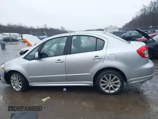 2011 Suzuki SX4 with VIN JS2YC5A41B6300385, listed as a IAAI auction lot 41570810 with 117,847 mi miles and . Bid and sale history available at DreamBid. Image 14.