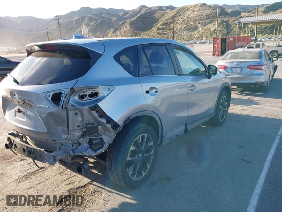 2016 Mazda CX-5 Grand Touring z VIN JM3KE2DY8G0709573, wystawiony jako IAAI lot #42021005 z przebiegiem 113 941 mil mil oraz . Historia ofert i sprzedaży dostępna na DreamBid. Obrazek 4.
