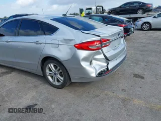2018 Ford Fusion SE z VIN 3FA6P0LU2JR281231, wystawiony jako IAAI lot #41963083 z przebiegiem 115 434 mil mil oraz . Historia ofert i sprzedaży dostępna na DreamBid. Obrazek 6.