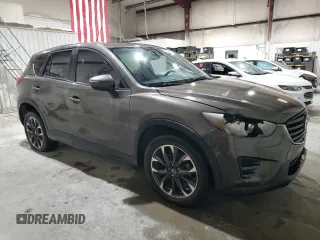 2016 Mazda CX-5 Grand Touring z VIN JM3KE2DY5G0821683, wystawiony jako Copart lot #51929905 z przebiegiem 119 392 mil mil oraz Czysty tytuł • Clean title. Historia ofert i sprzedaży dostępna na DreamBid. Obrazek 4.