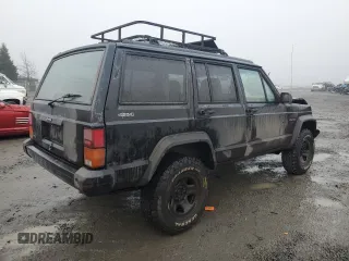 1996 Jeep Cherokee Sport with VIN 1J4FJ68S0TL288244, listed as a Copart auction lot 87801025 with 218,356 mi miles and Salvage Title. Bid and sale history available at carsss.com. Image 3.