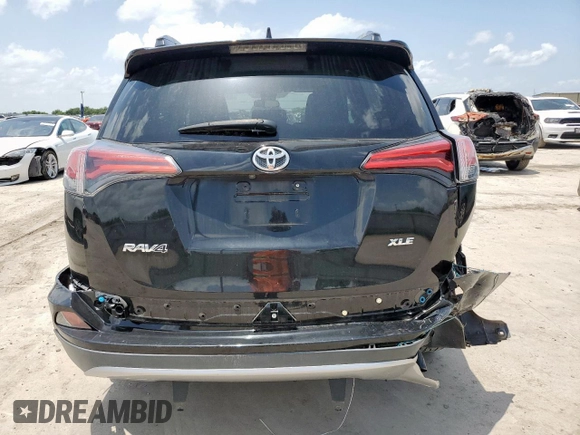 2018 Toyota RAV4 XLE with VIN 2T3WFREV2JW433186, listed as a Copart auction lot 61008705 with 57,310 mi miles and Salvage title. Bid and sale history available at DreamBid. Image 6.