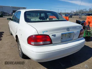1998 Mazda 626 DX with VIN 1YVGF22CXW5702980, listed as a IAAI auction lot 41778063 with 104,672 mi miles. Bid and sale history available at carsss.com. Image 3.