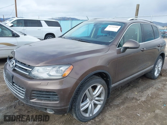 2013 Volkswagen Touareg Lux with VIN WVGEF9BP1DD012851, listed as a IAAI auction lot 41732391 with 123,283 mi miles and . Bid and sale history available at DreamBid. Image 2.