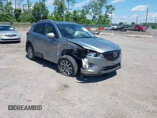 2014 Mazda CX-5 Touring z VIN JM3KE4CY3E0397995, wystawiony jako IAAI lot #42390778 z przebiegiem 79 515 mil mil oraz . Historia ofert i sprzedaży dostępna na DreamBid. Obrazek 1.