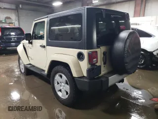 2011 Jeep Wrangler Sahara with VIN 1J4AA5D19BL577347, listed as a Copart auction lot 80340124 with 148,986 mi miles and Salvage Title. Bid and sale history available at DreamBid. Image 2.