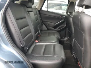 2016 Mazda CX-5 Grand Touring z VIN JM3KE4DY2G0637779, wystawiony jako Copart lot #52001805 z przebiegiem 184 381 mil mil oraz Czysty tytuł • Clean title. Historia ofert i sprzedaży dostępna na DreamBid. Obrazek 11.