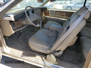 1985 Cadillac Eldorado z VIN 1G6EL578XFE661216, wystawiony jako Copart lot #54606984 z przebiegiem 12 462 mil mil oraz Szkody całkowita. Historia ofert i sprzedaży dostępna na DreamBid. Obrazek 7.