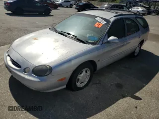 1999 Ford Taurus SE z VIN 1FAFP58S3XG168635, wystawiony jako Copart lot #71321624 z przebiegiem 103 308 mil mil oraz Tytuł czysty. Historia ofert i sprzedaży dostępna na DreamBid. Obrazek 1.