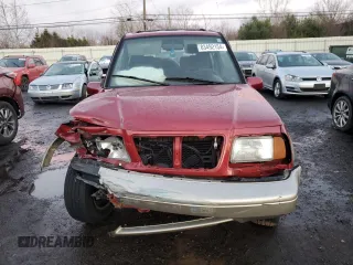 1996 Suzuki Sidekick z VIN JS3TD21V2T4103586, wystawiony jako Copart lot #83492154 z przebiegiem 98 298 mil mil oraz Szkody całkowita. Historia ofert i sprzedaży dostępna na DreamBid. Obrazek 5.