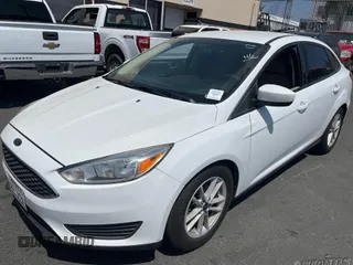 2018 Ford Focus SE z VIN 1FADP3F20JL259181, wystawiony jako IAAI lot #42400276 z przebiegiem 161 473 mil mil oraz . Historia ofert i sprzedaży dostępna na DreamBid. Obrazek 6.