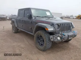 2023 Jeep Gladiator Rubicon z VIN 1C6JJTBG6PL574633, wystawiony jako IAAI lot #41938131 z przebiegiem 39 241 mil mil oraz . Historia ofert i sprzedaży dostępna na DreamBid. Obrazek 1.