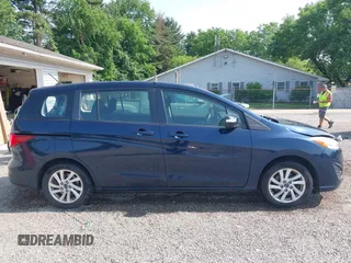 2015 Mazda 5 Sport z VIN JM1CW2BL9F0187973, wystawiony jako IAAI lot #42378711 z przebiegiem 97 543 mil mil oraz . Historia ofert i sprzedaży dostępna na DreamBid. Obrazek 13.