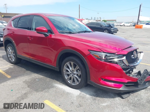 2021 Mazda CX-5 Grand Touring with VIN JM3KFADM6M1373111, listed as a IAAI auction lot 42784431 with 14,374 mi miles and . Bid and sale history available at DreamBid. Image 1.