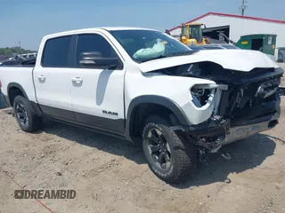 2021 Ram 1500 Rebel z VIN 1C6SRFLT0MN559314, wystawiony jako IAAI lot #42152002 z przebiegiem 75 314 mil mil oraz . Historia ofert i sprzedaży dostępna na DreamBid. Obrazek 1.
