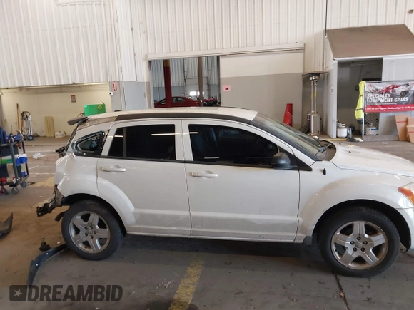 2009 Dodge Caliber SXT with VIN 1B3HB48A89D116734, listed as a IAAI auction lot 41959281 with 209,136 mi miles and . Bid and sale history available at DreamBid. Image 14.