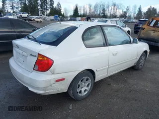 2004 Hyundai Accent GL with VIN KMHCG35C74U303431, listed as a IAAI auction lot 41725717 with 211,893 mi miles. Bid and sale history available at carsss.com. Image 4.