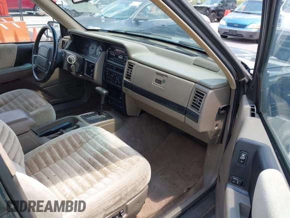1995 Jeep Grand Cherokee Laredo with VIN 1J4FX58S0SC716398, listed as a IAAI auction lot 42647346 with 58,184 mi miles and . Bid and sale history available at DreamBid. Image 5.