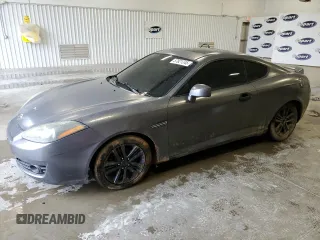 2007 Hyundai Tiburon GS z VIN KMHHM66D57U261613, wystawiony jako Copart lot #57821245 z przebiegiem 185 489 mil mil oraz Szkoda całkowita • Salvage title. Historia ofert i sprzedaży dostępna na DreamBid. Obrazek 1.